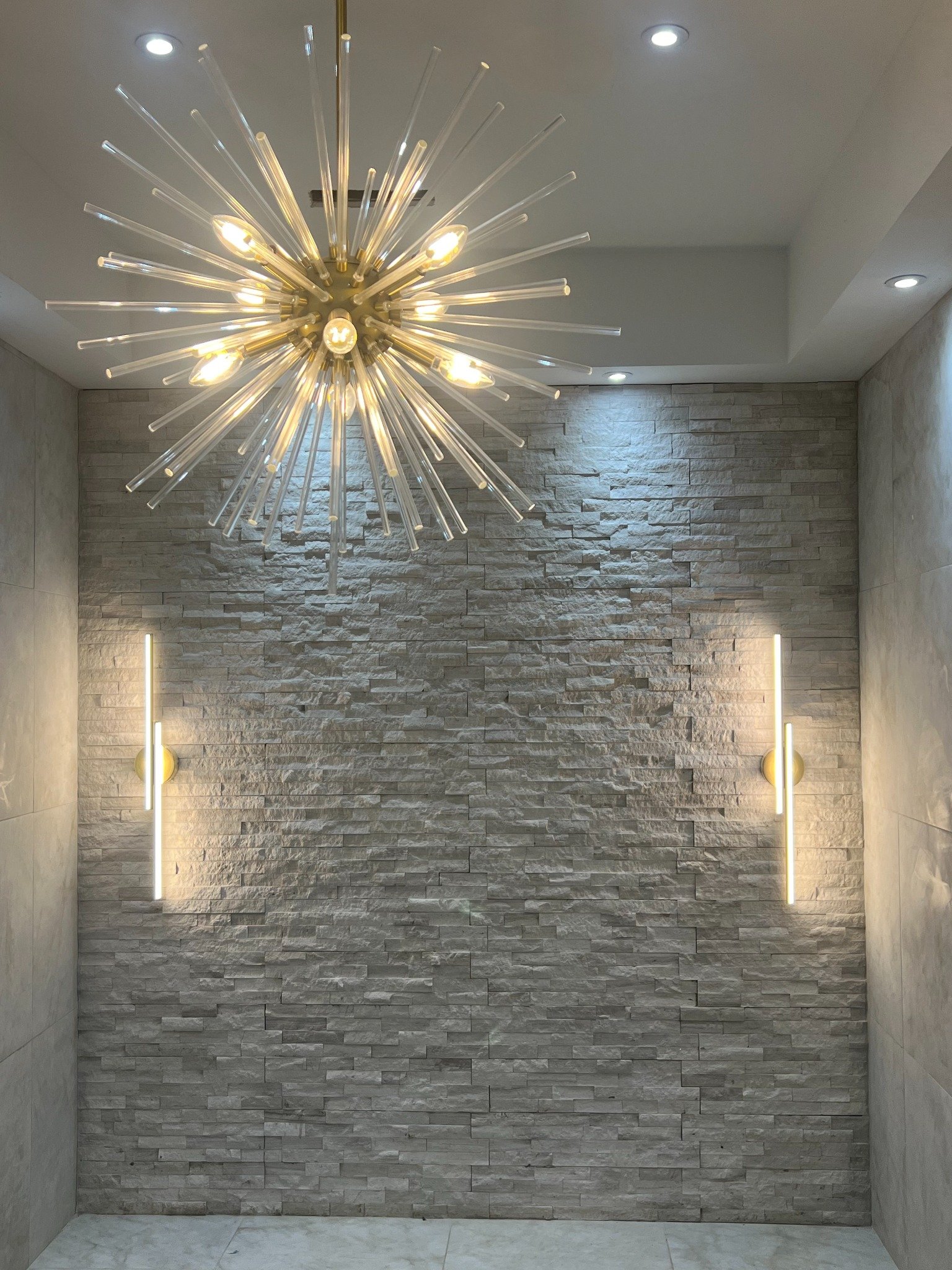 Finished stone accent wall and custom lighting remodeling project